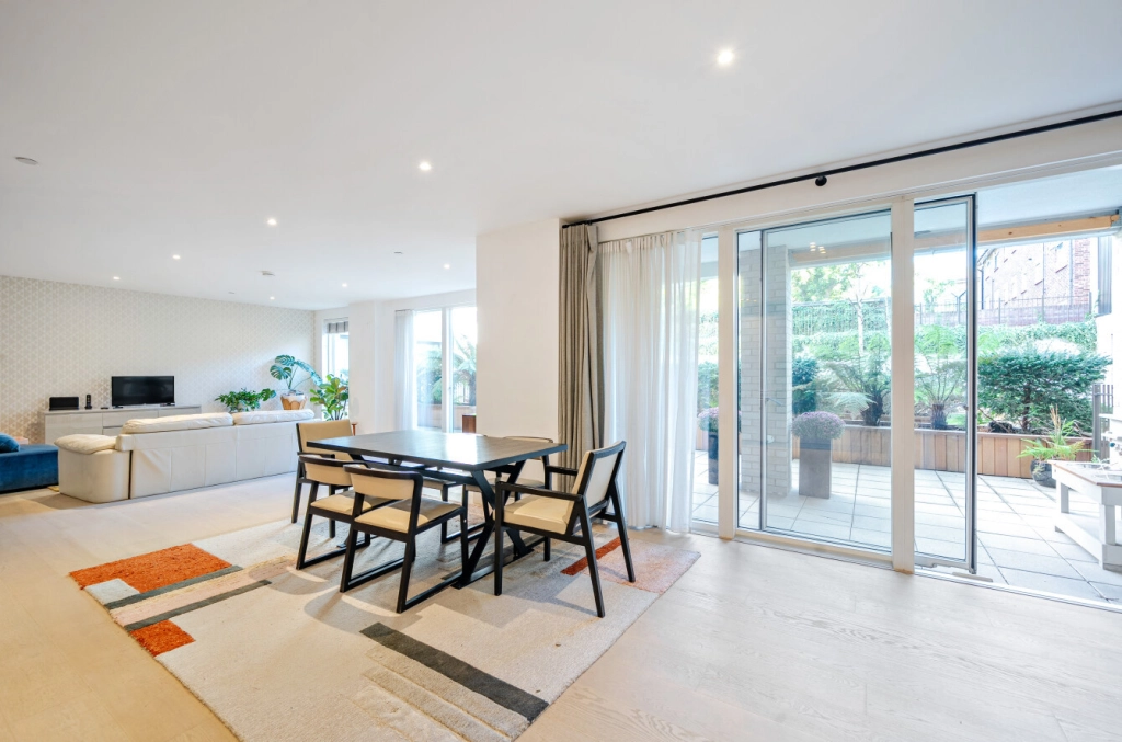 Open-plan reception and dining room with floor-to-ceiling terrace doors at The Avenue, Queen's Park NW6