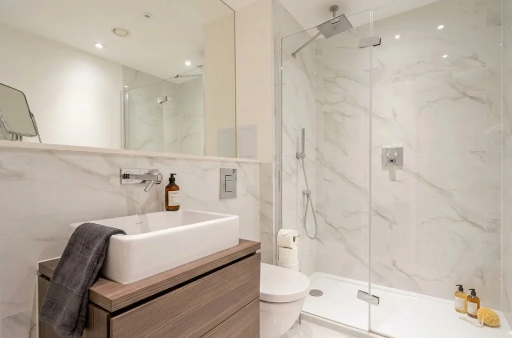 En-suite shower room with marble tiling at The Avenue, Queen's Park NW6